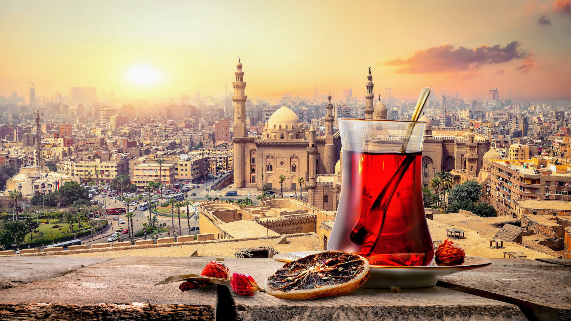 Traditional tea glass with Islamic Cairo mosque and minarets in background