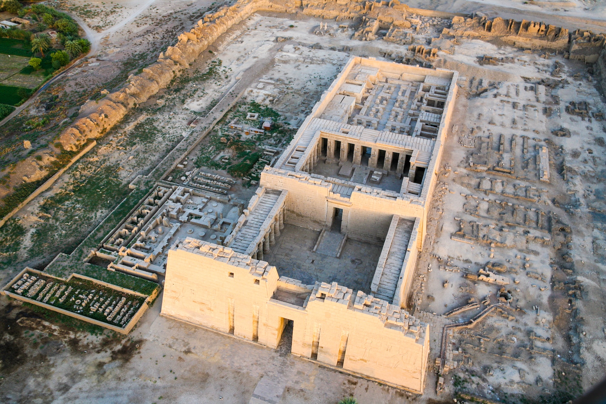 Aerial view of ancient Egyptian temple complex showing multiple structures and architectural elements