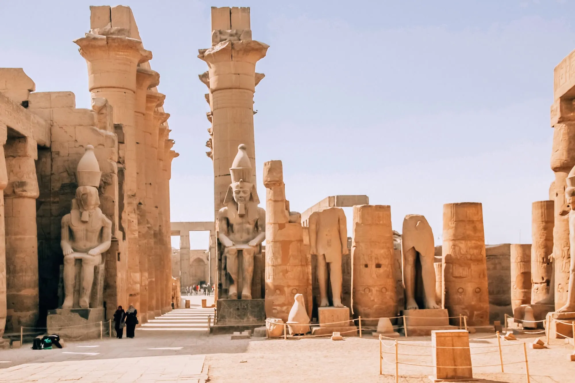 Ancient Egyptian temple complex with columns, statues, and hieroglyphic carvings at Karnak