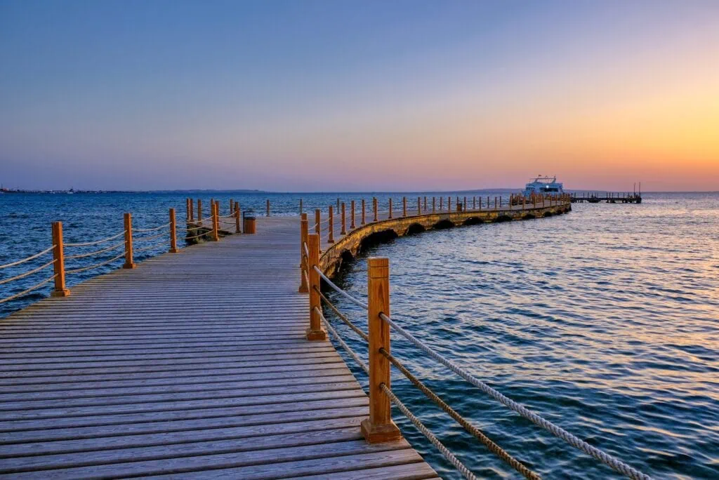 View of the promenade boardwalk over the Red Sea during sunrise in Hurghada Egypt