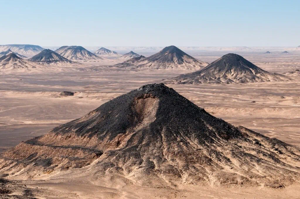 Volcanic mountains and dark rock formations in the Black Desert near Bahariya Oasis, Bahariya Oasis