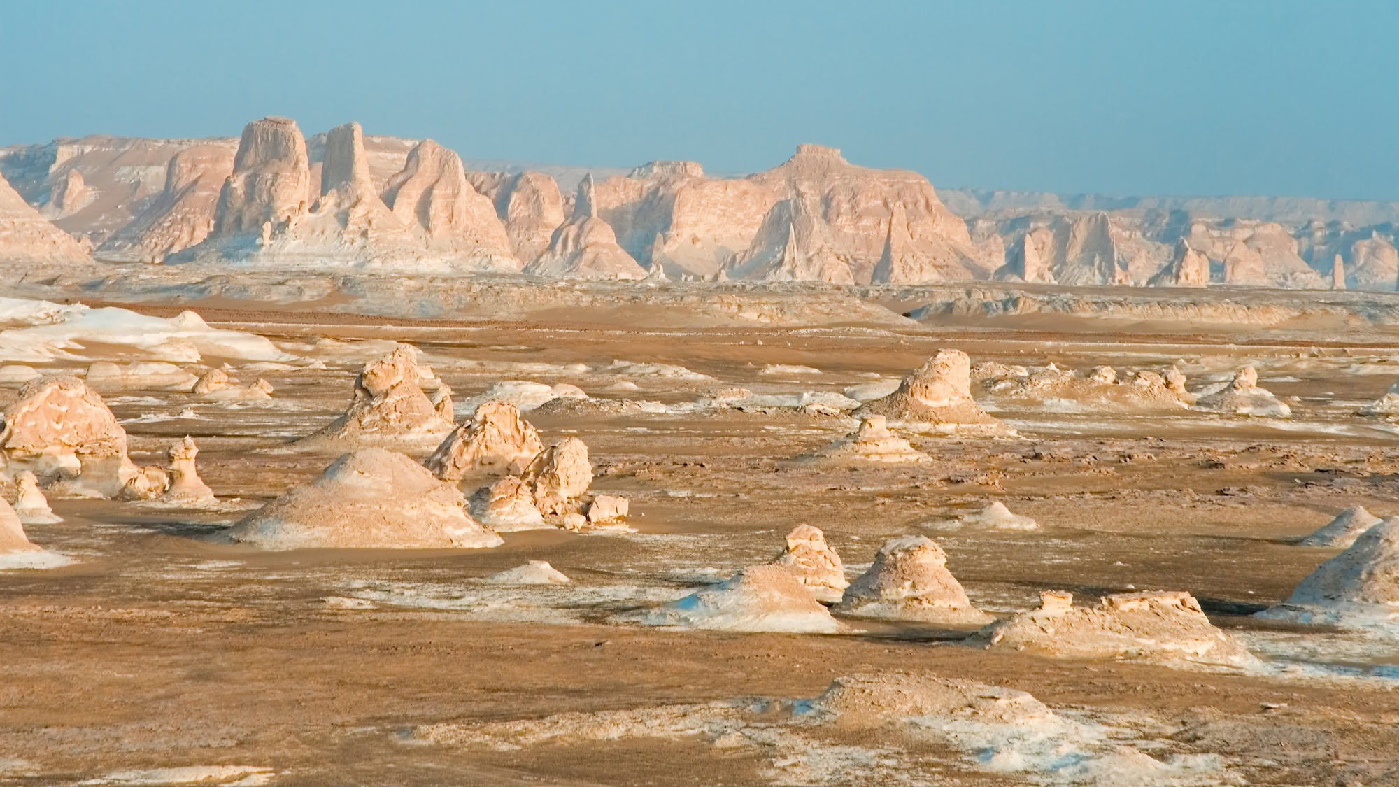 Expansive limestone formations and desert valley in Egypt's White Desert National Park