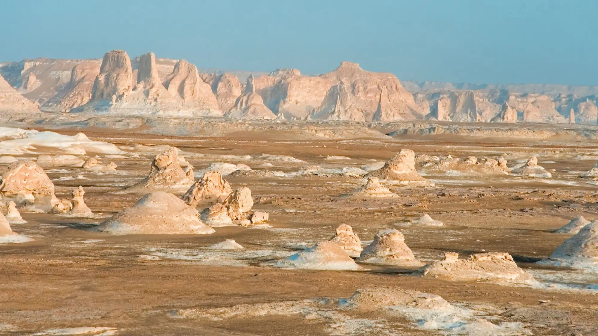 Surreal white chalk and limestone formations rising from the desert sand in the White Desert National Park near Farafra in Egypt's Western Desert