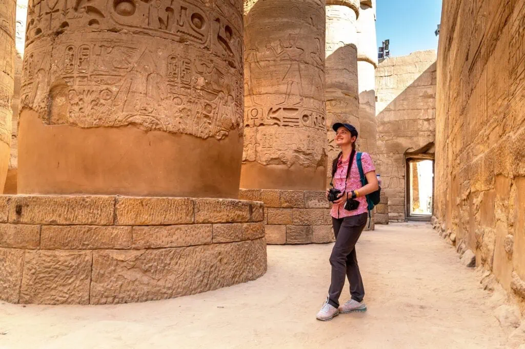 Tourist enjoying a sunny visit to Karnak Temple, Luxor