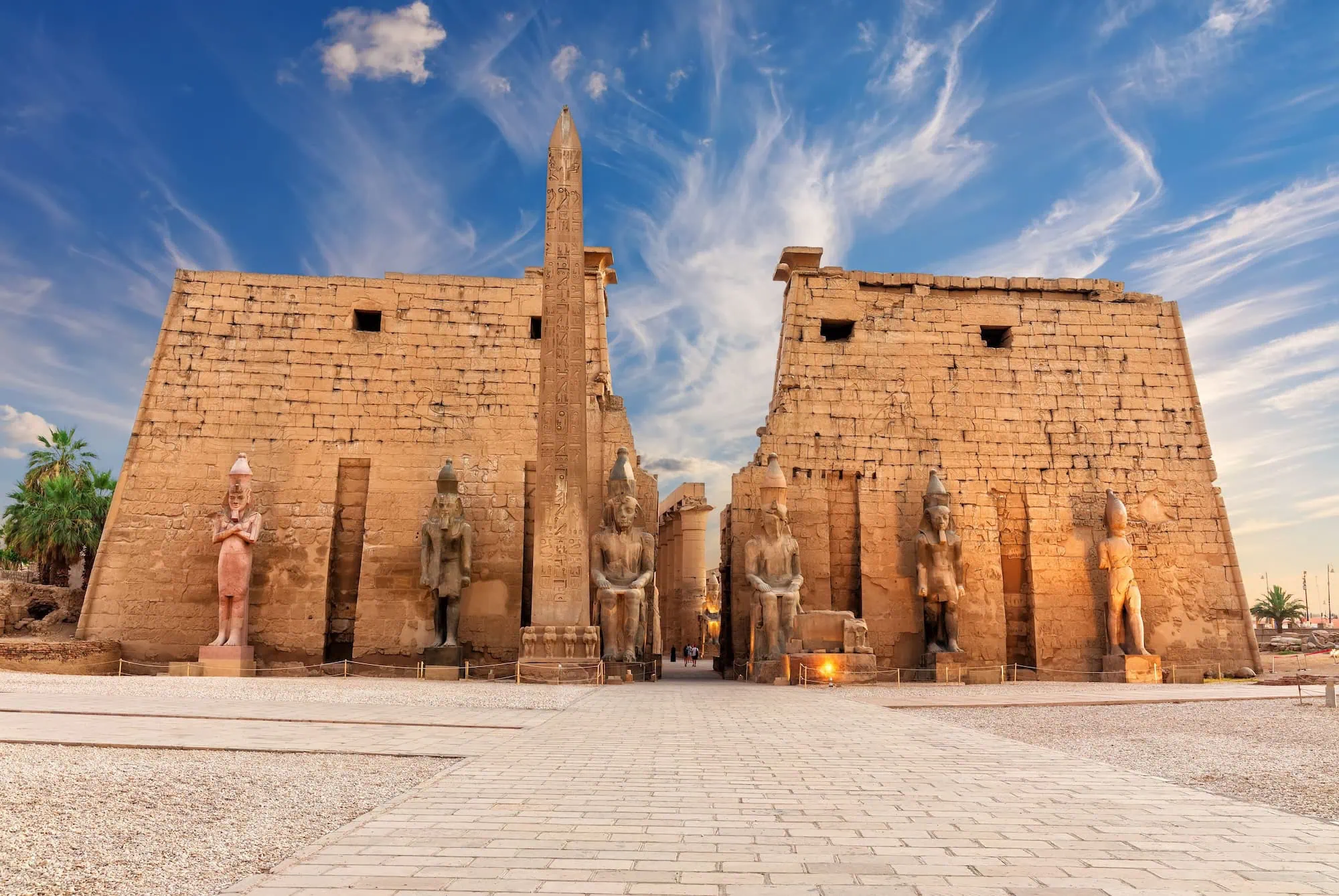 Ancient Luxor Temple with towering obelisk, sphinx statues, and stone columns in Egypt