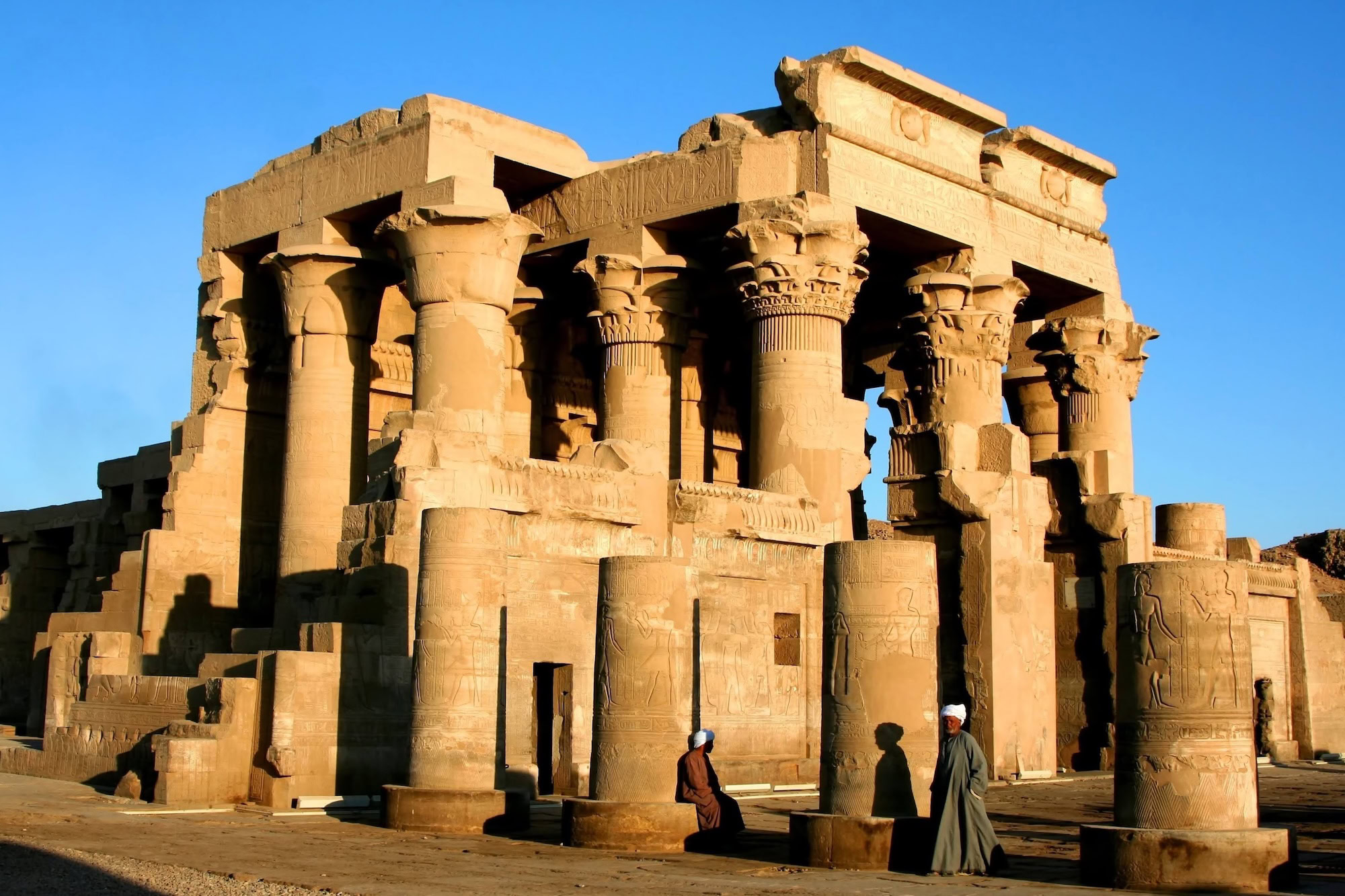 Restored Kom Ombo Temple with ancient columns, hieroglyphics, and tourists exploring the archaeological site