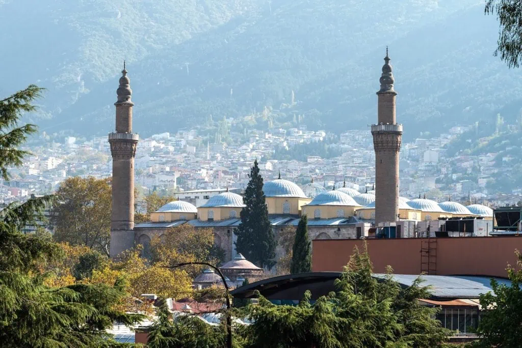 Bursa Grand Mosque (Ulu Cami) with multiple domes and twin minarets overlooking the cityscape, Bursa