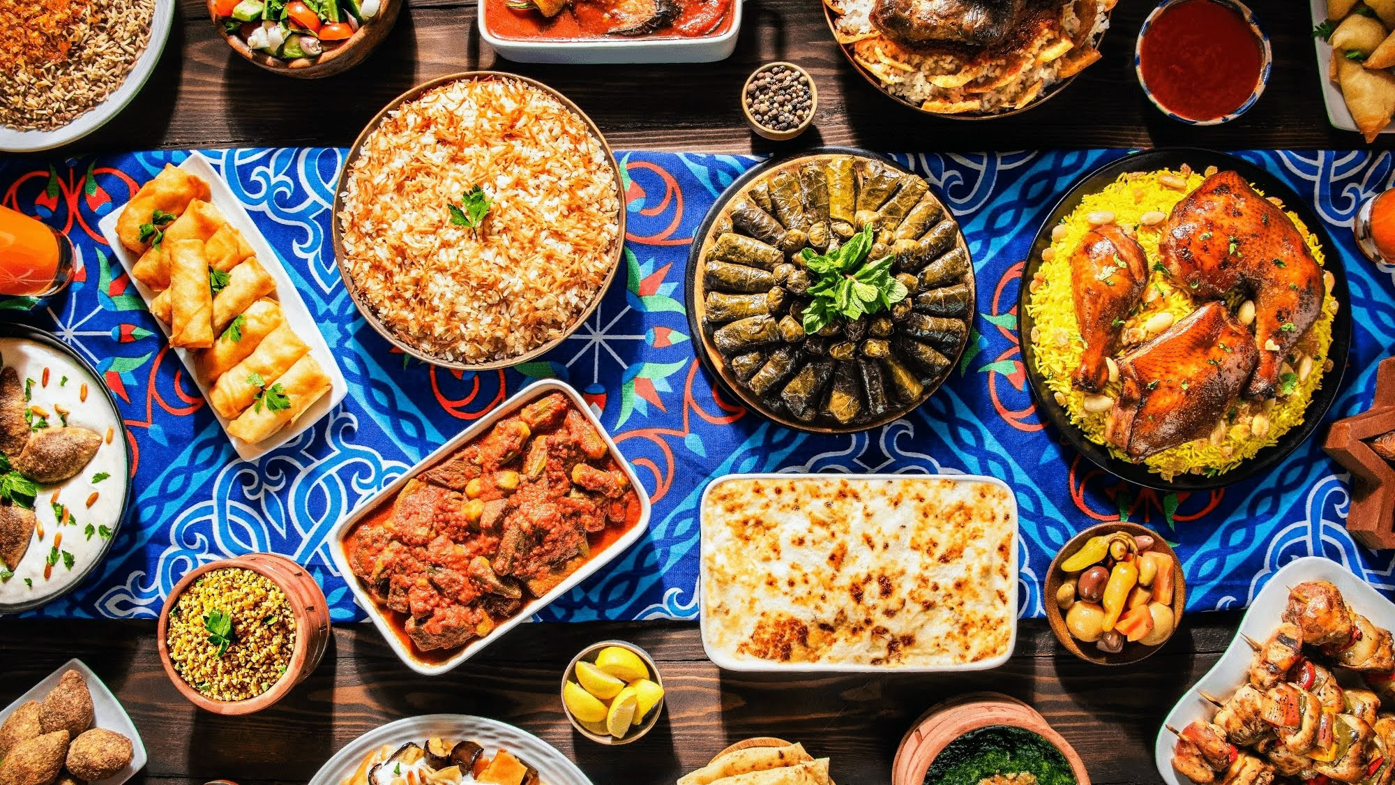 Traditional Middle Eastern feast with rice dishes, stuffed grape leaves, grilled chicken and flatbread