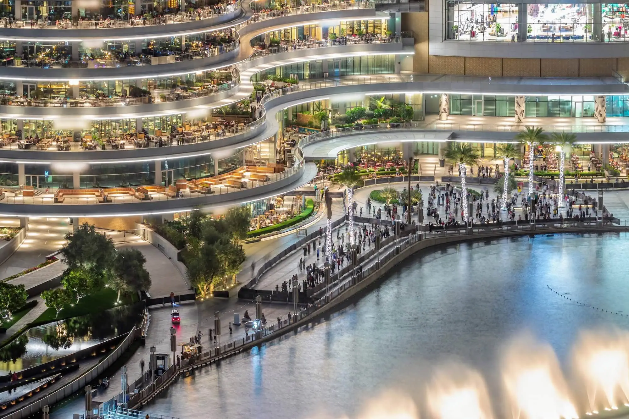 Interior view of Dubai Mall showing multiple curved levels and walkways with visitors