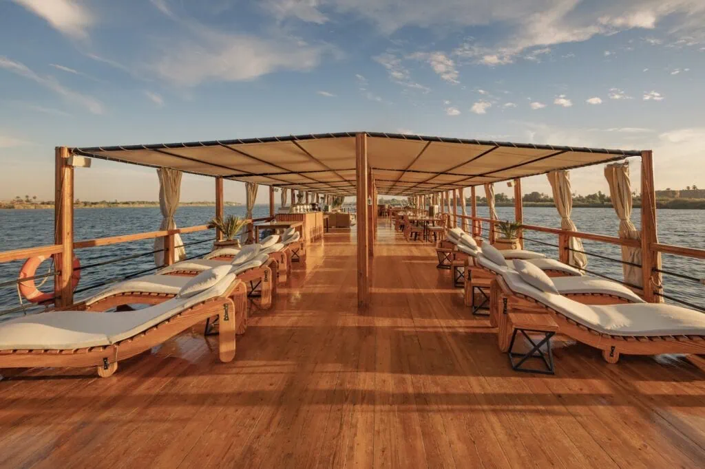 Sun deck with loungers and shaded seating aboard the Nuut or Nuun Dahabiya sailing on the Nile, Nuut or Nuun Dahabiya sun deck, Aswan