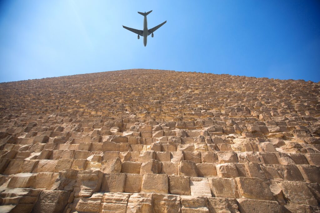 Plane passing above the world heritage site of the Giza pyramids