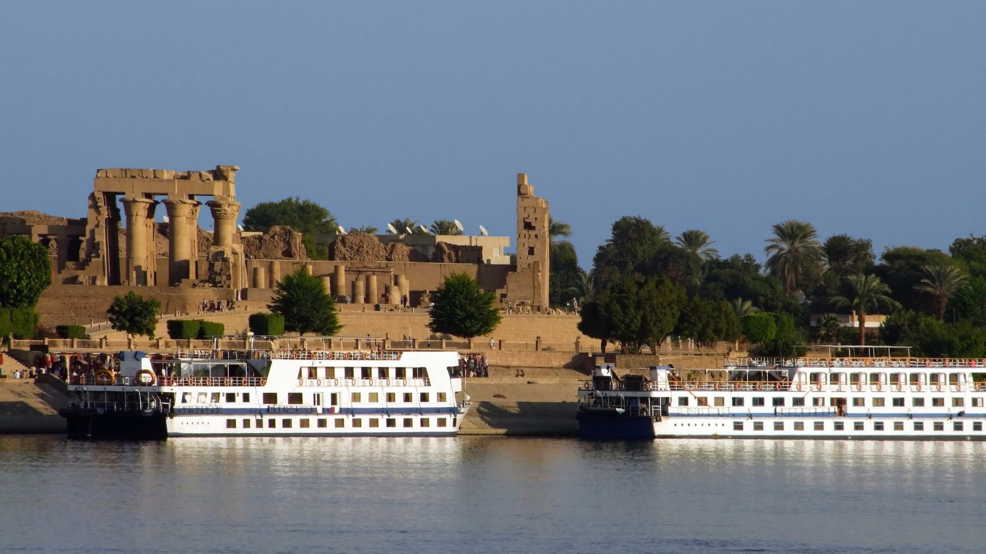 Temple of Kom Ombo with Nile River cruise ships docked nearby