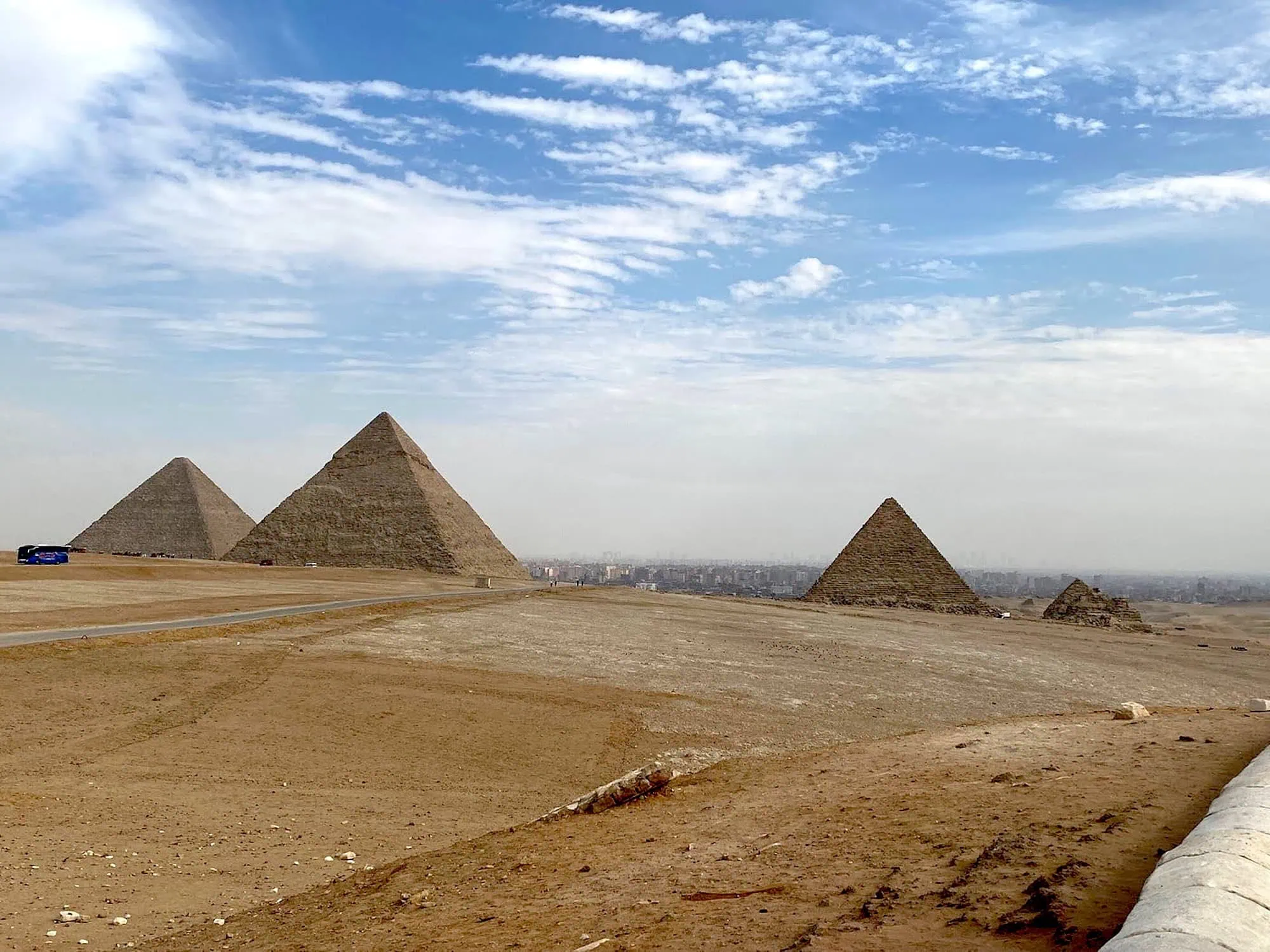Panoramic view of the three Pyramids of Giza (Khufu, Khafre, and Menkaure) on the Giza Plateau outside Cairo, Egypt
