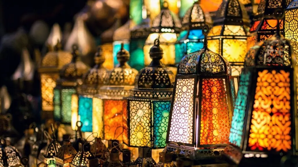 Traditional fanous (Ramadan lanterns) on display at a market stall in Khan El Khalili bazaar, Cairo, Egypt — colourful metal-and-glass lanterns sold during the Ramadan season