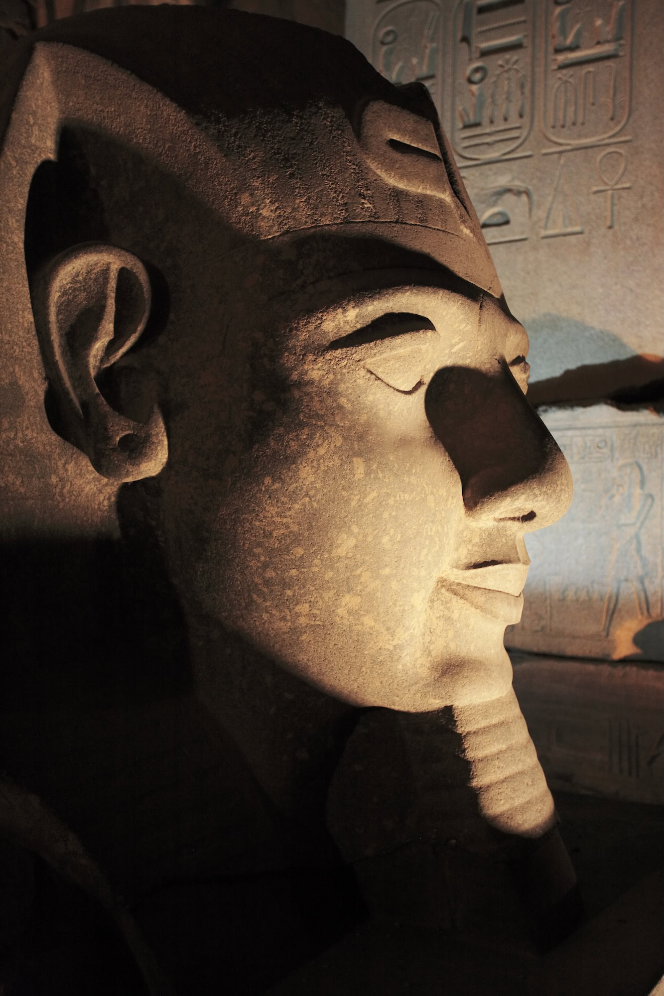 Ancient Egyptian pharaoh statue with hieroglyphics carved in stone