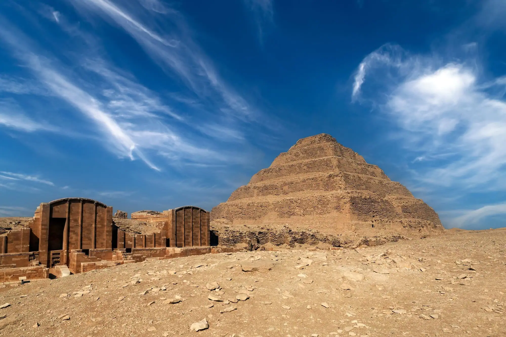 Step Pyramid of Djoser at Saqqara, Egypt against blue sky