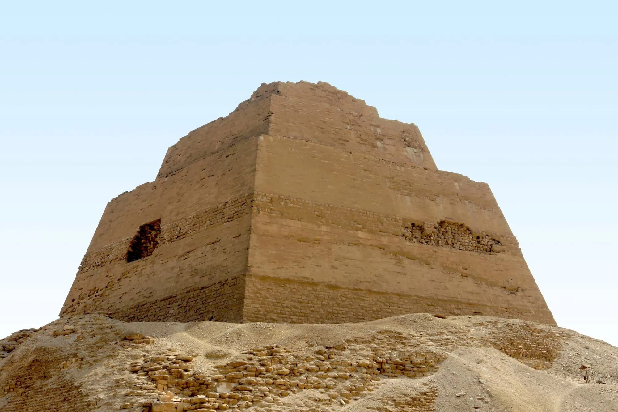 Ancient Meidum Pyramid ruins rising from desert sands in Egypt