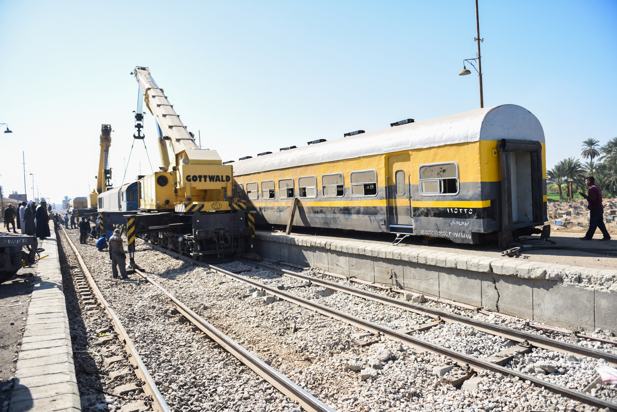Train at railway platform with tracks and locomotive in Egypt