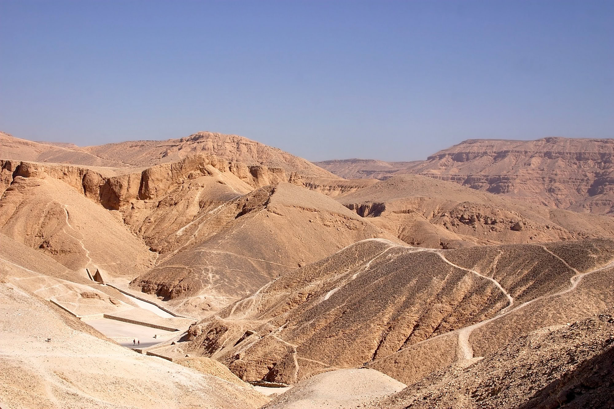 Desert landscape of Valley of the Kings with limestone cliffs and ancient pathways