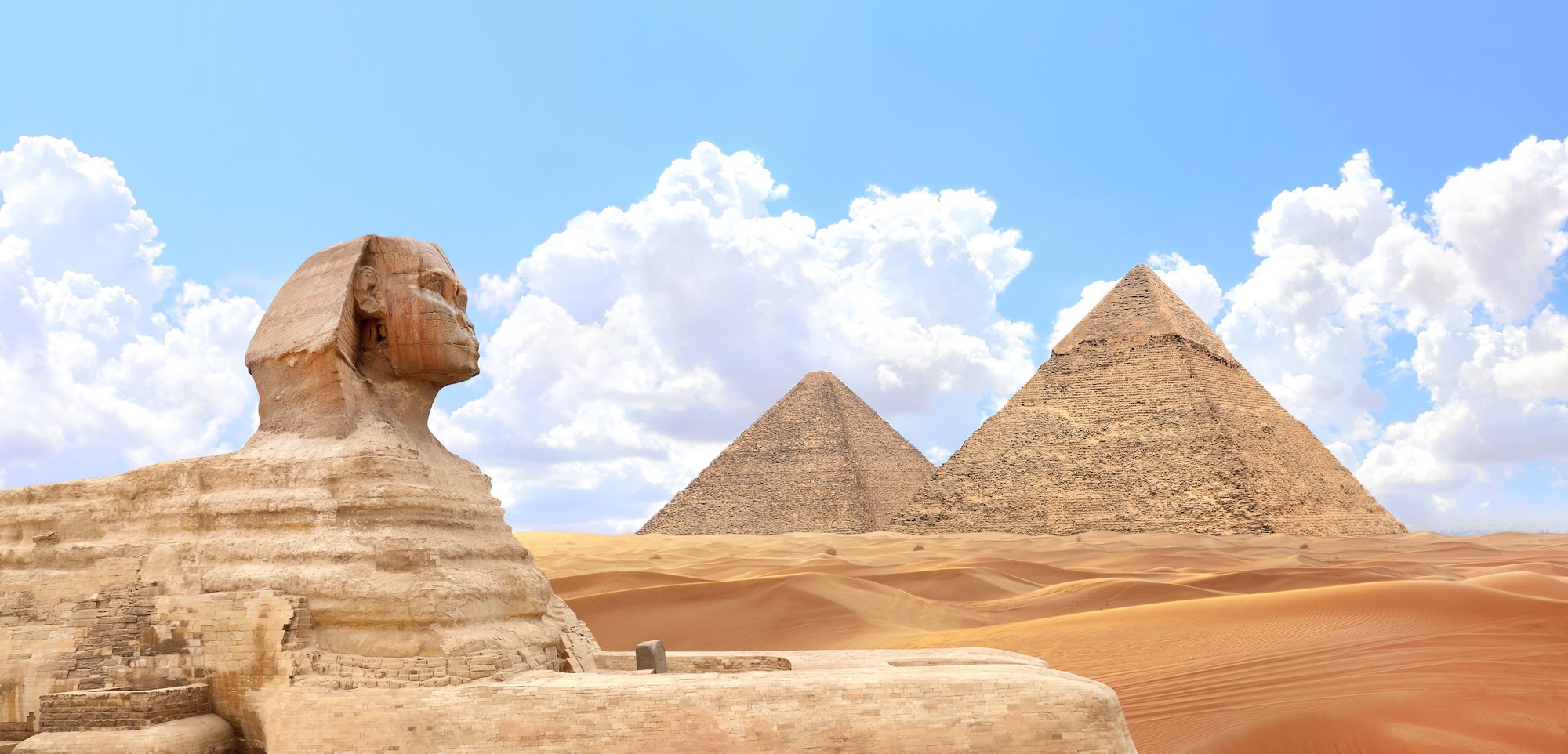 Famous Great Sphinx and pyramids of Chephren and Cheops, Cairo, Egypt. Great Pyramids and ancient statue of Sphinx,
