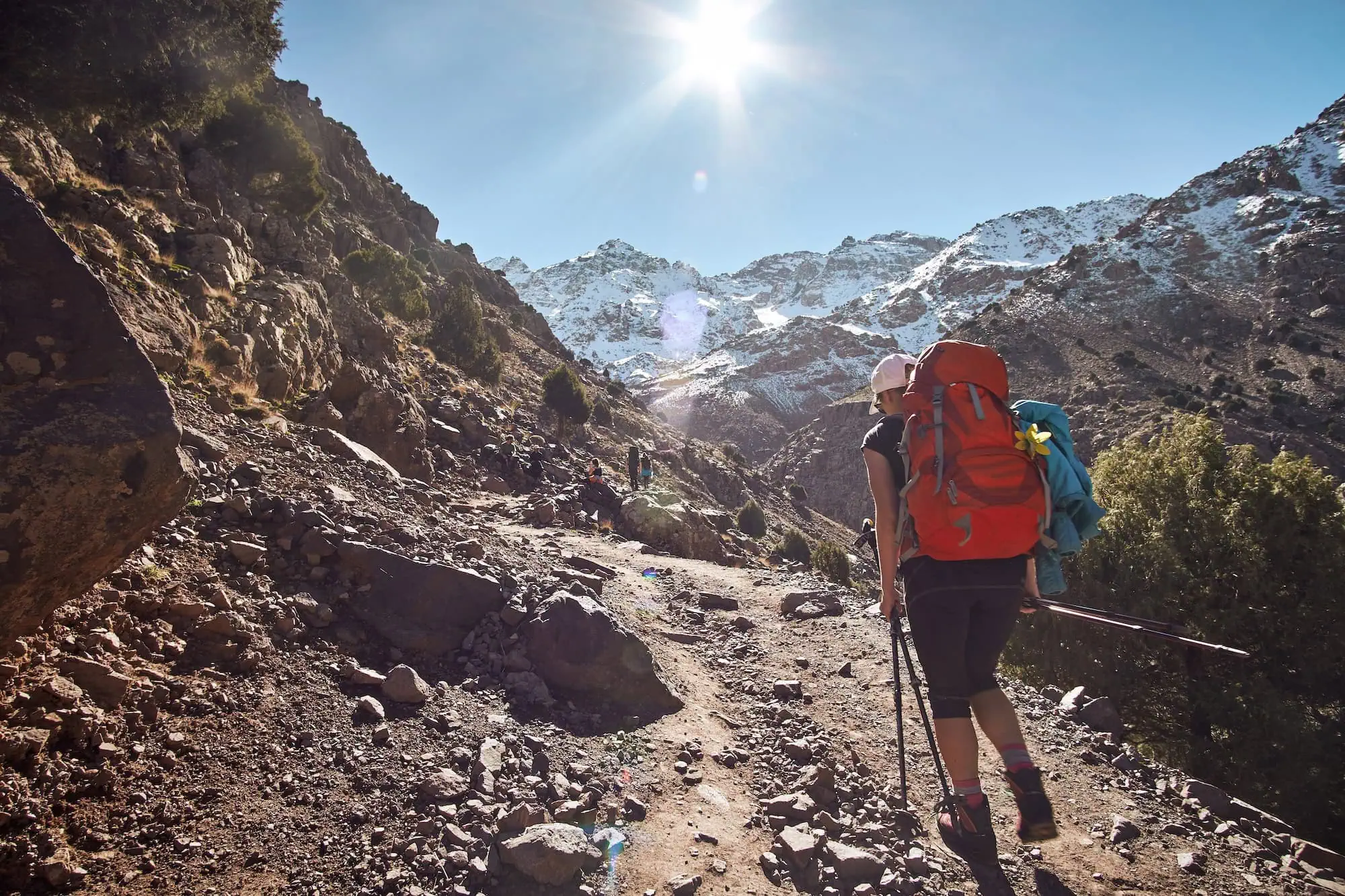 Hiker on a mountain trail in Morocco's High Atlas, the range that separates the imperial cities from the Sahara and rises to 4,167 metres at Mount Toubkal.