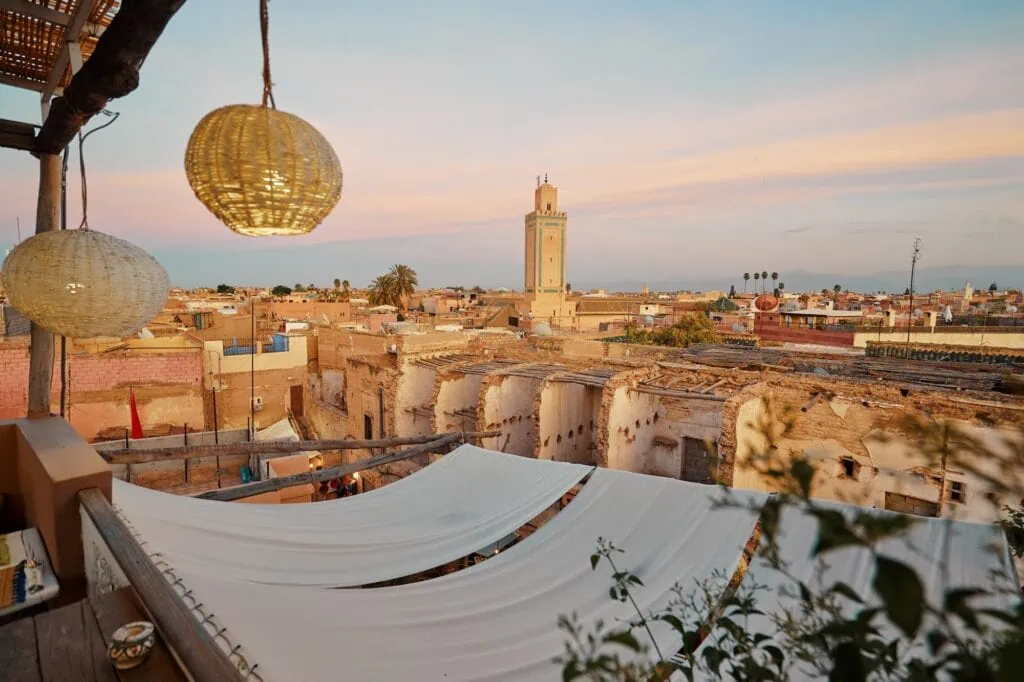 Marrakesh Medina rooftop terrace view overlooking dense old town buildings and surrounding landscape