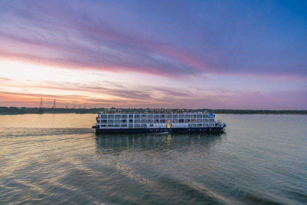 Large Nile cruise ship sailing on calm water under a clear sky