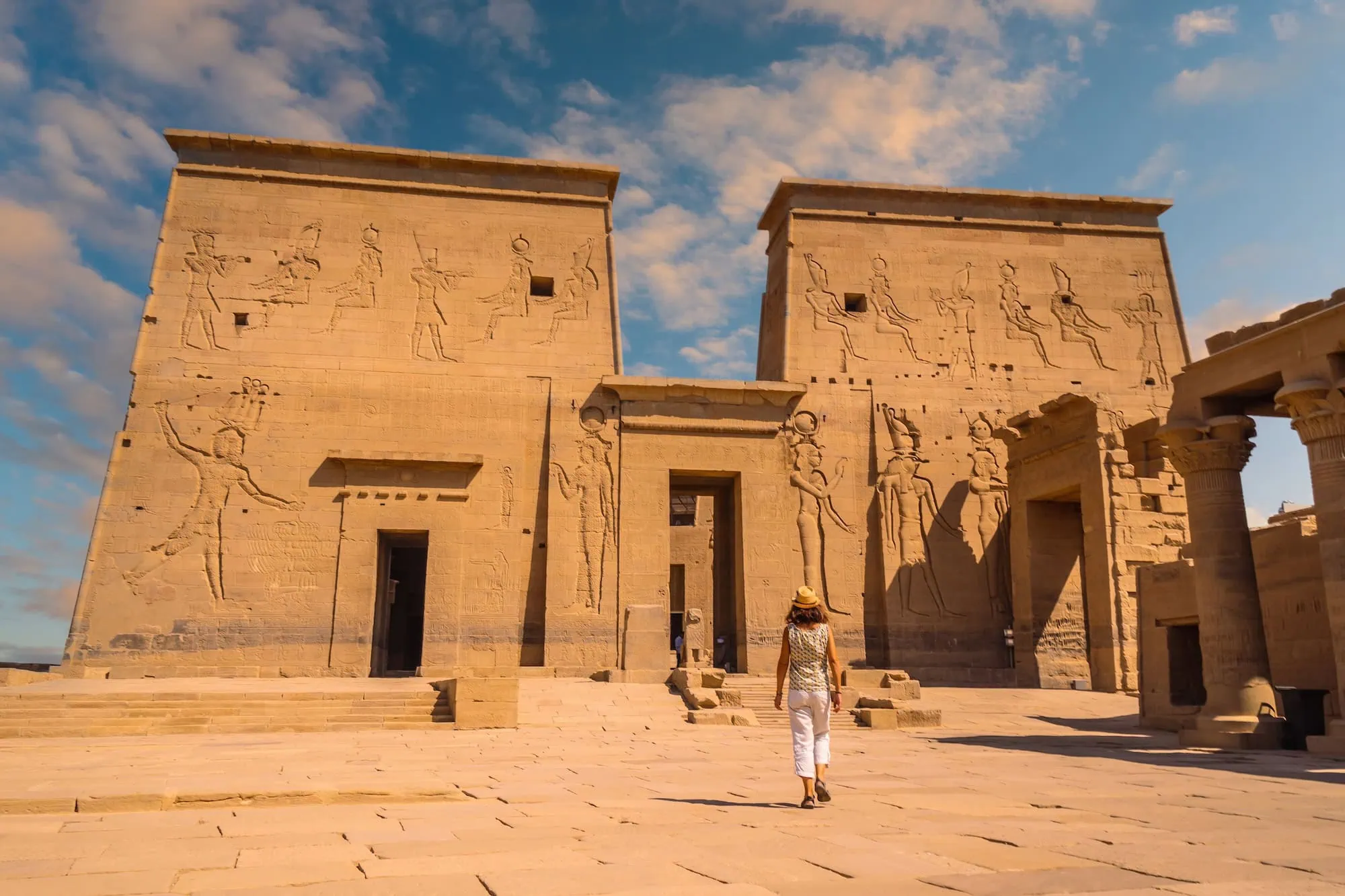 Ancient Philae Temple with detailed hieroglyphic carvings on stone pylons and columns