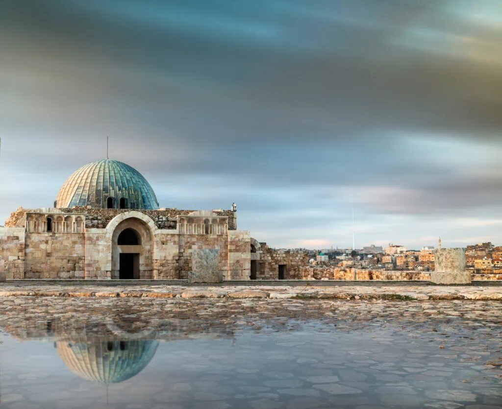 Stone ruins and columns spread across the hilltop of Amman Citadel overlooking the city, Amman