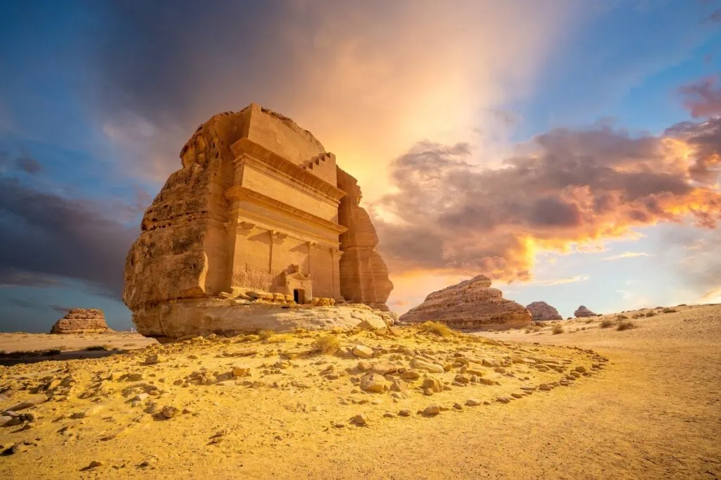 A monumental rock-cut Nabataean tomb carved into a sandstone outcrop at Hegra (Madain Saleh) in AlUla, Saudi Arabia.
