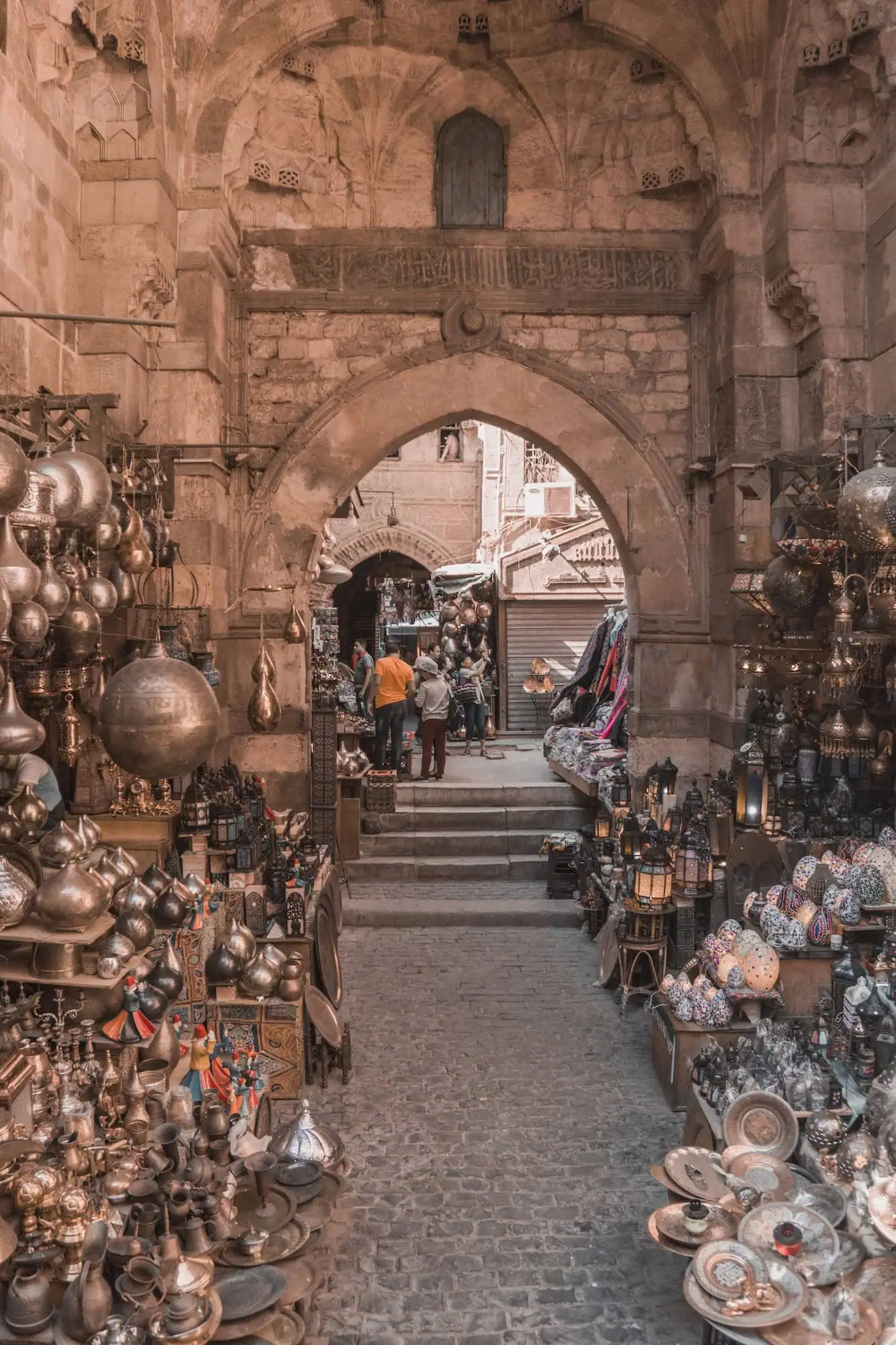 Traditional craftsmen's shops in the Khan El Khalili bazaar in Islamic Cairo, displaying metalwork, lamps, and handmade goods, Egypt.