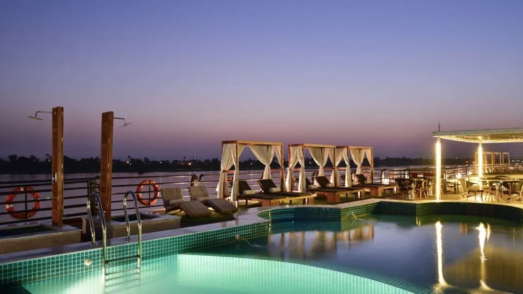 The upper sun deck and swimming pool of a Luxury Nile Cruise vessel sailing the Nile between Luxor and Aswan, Egypt.