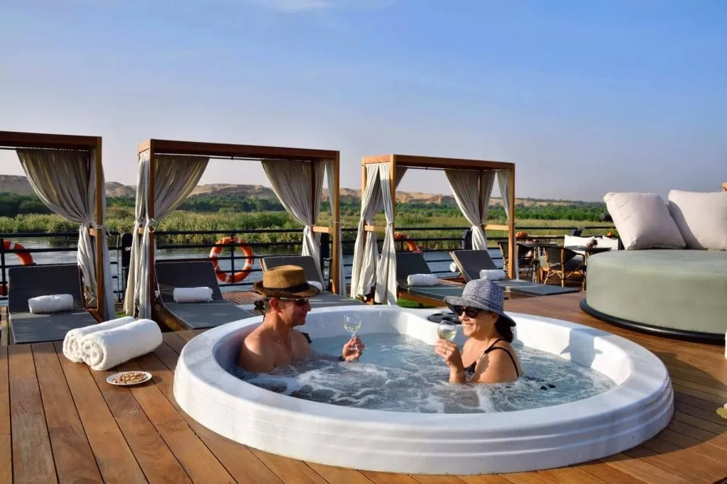 Couple relaxing in the deck jacuzzi onboard a luxury Nile cruise - Egypt Christmas Holidays
