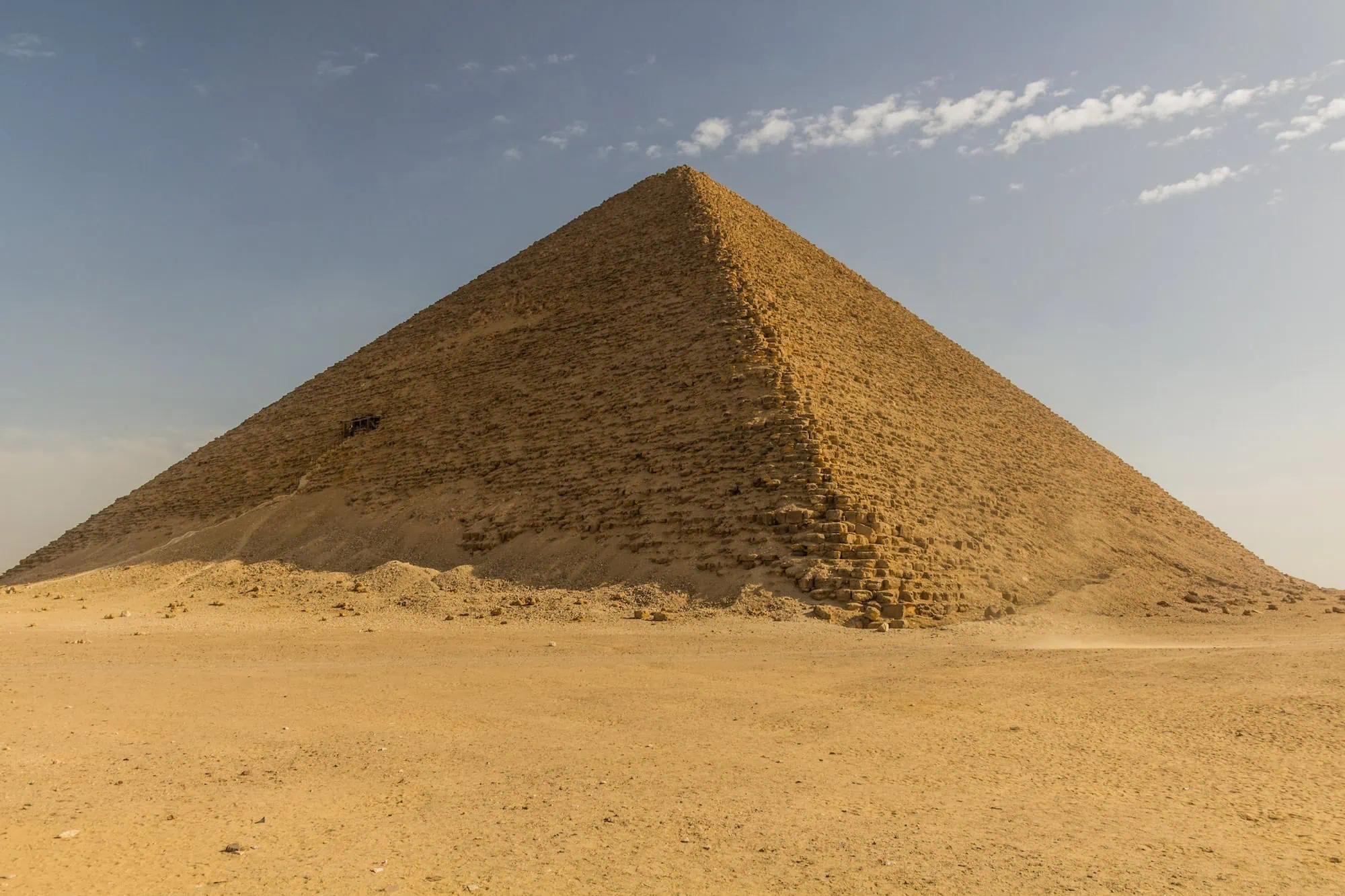 The Red Pyramid at Dahshur showing its complete triangular form rising above the surrounding desert landscape