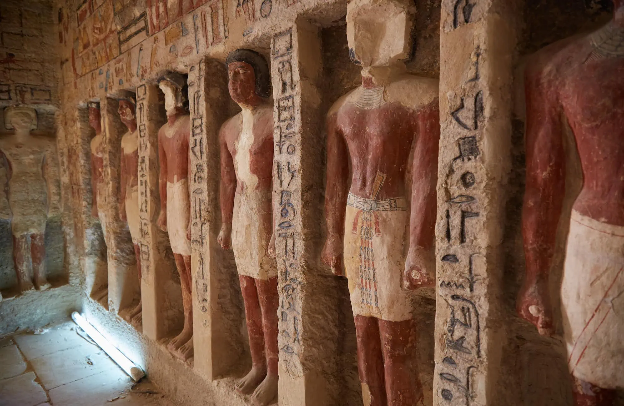 Antichi geroglifici e sculture egizie in una tomba con guide esperte
