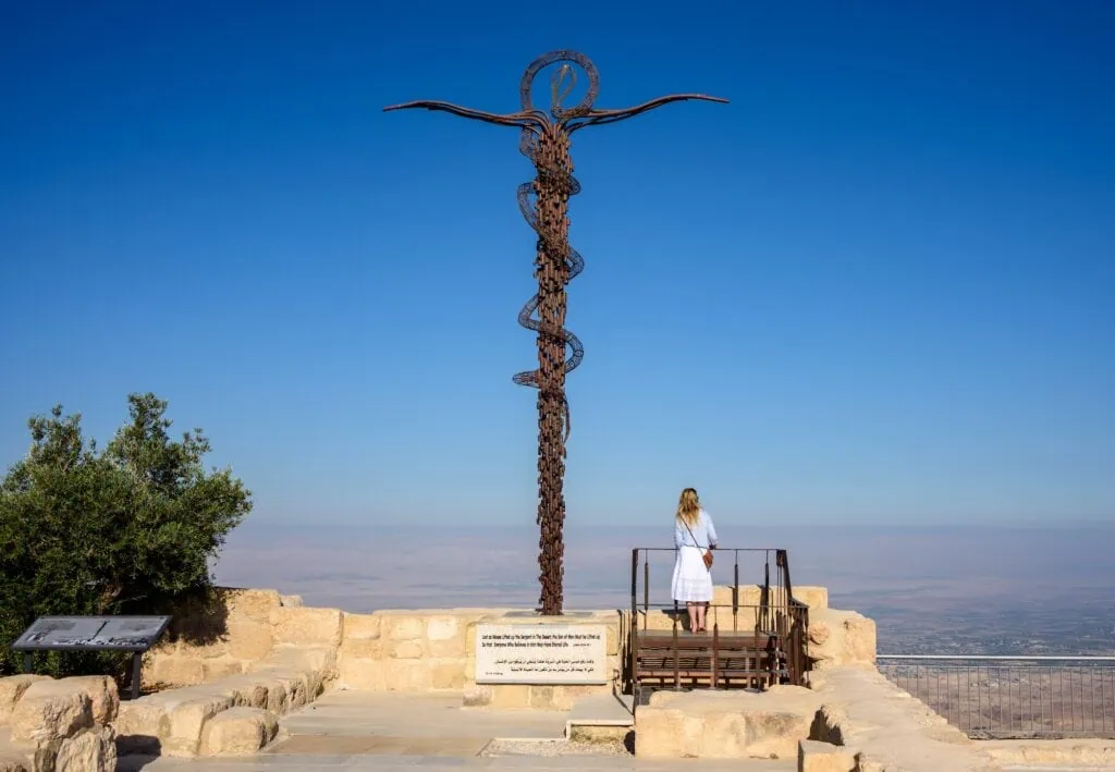 Serpentine cross sculpture on Mount Nebo overlooking valley landscape in Mount Nebo