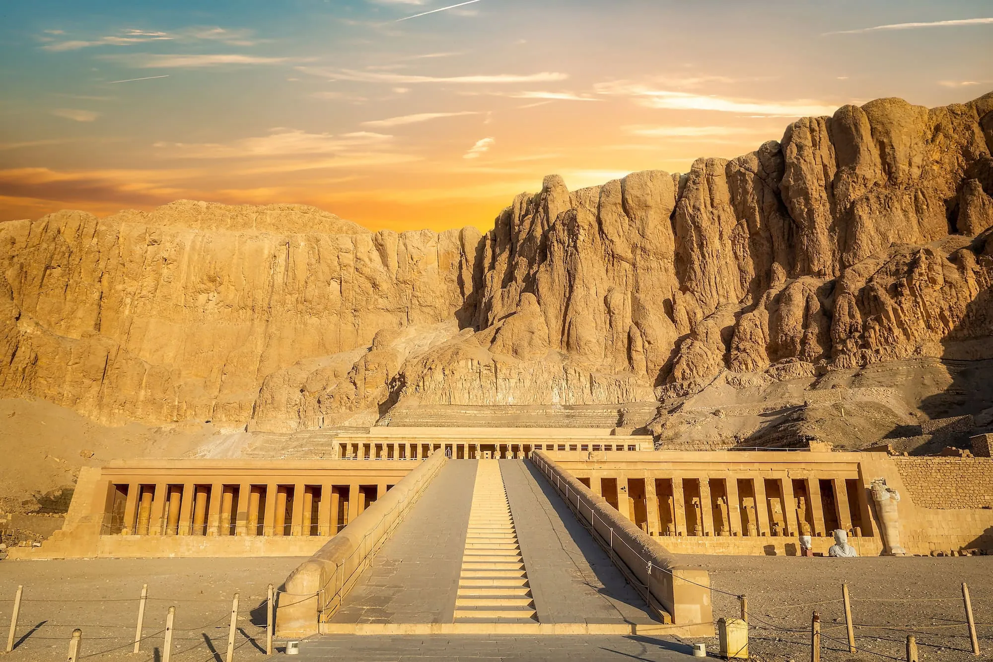 Queen Hatshepsut's mortuary temple carved into limestone cliffs with terraced columns and stairs
