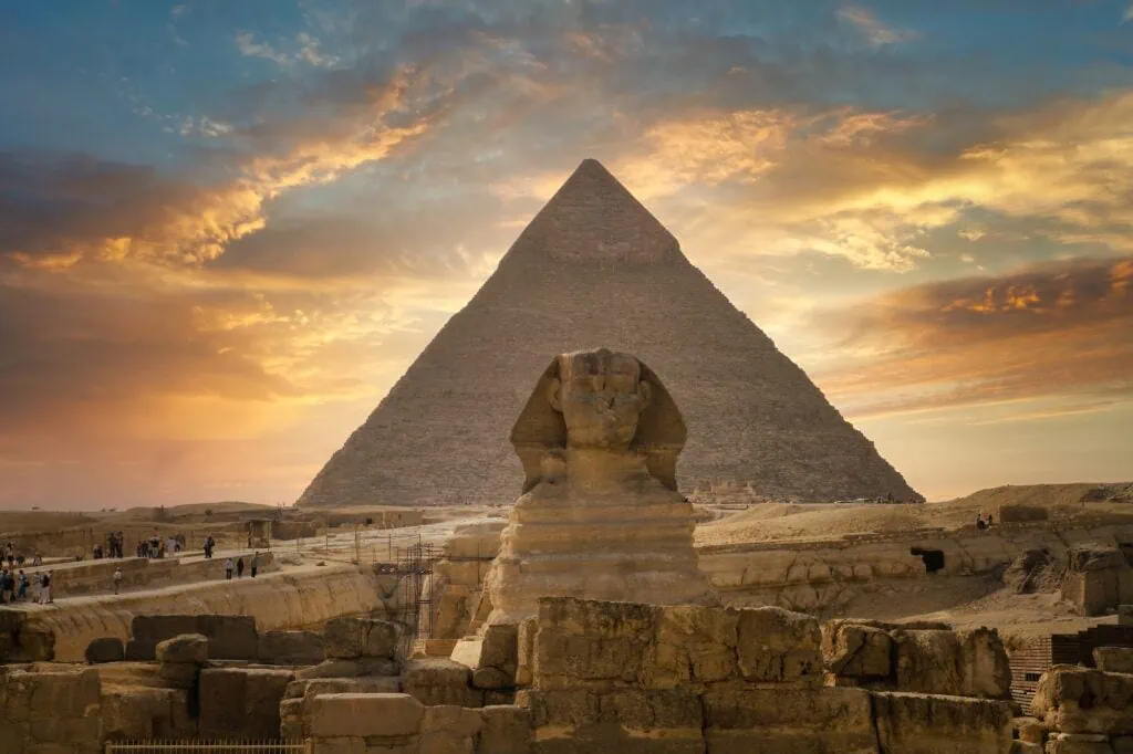 The Great Sphinx of Giza in front of the Pyramid of Khafre at sunset, the 4,500-year-old monumental pair on the Giza Plateau west of Cairo.