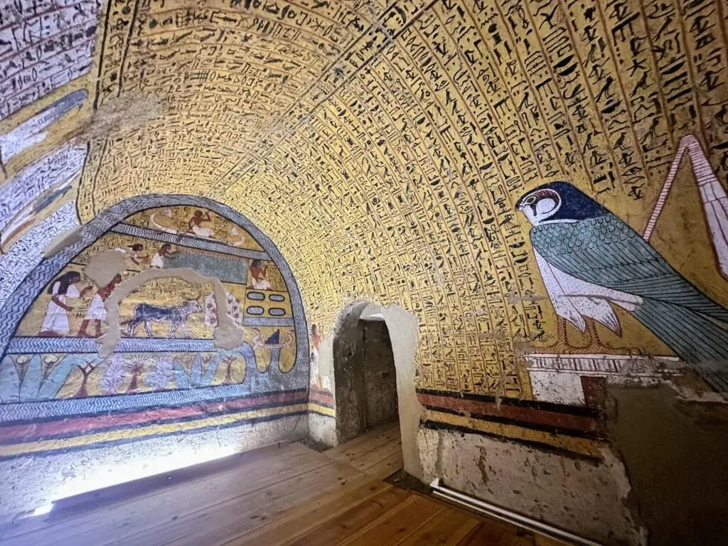 Painted wall scenes and carved inscriptions inside the Tomb of Sennutem at Deir el-Medina, Luxor