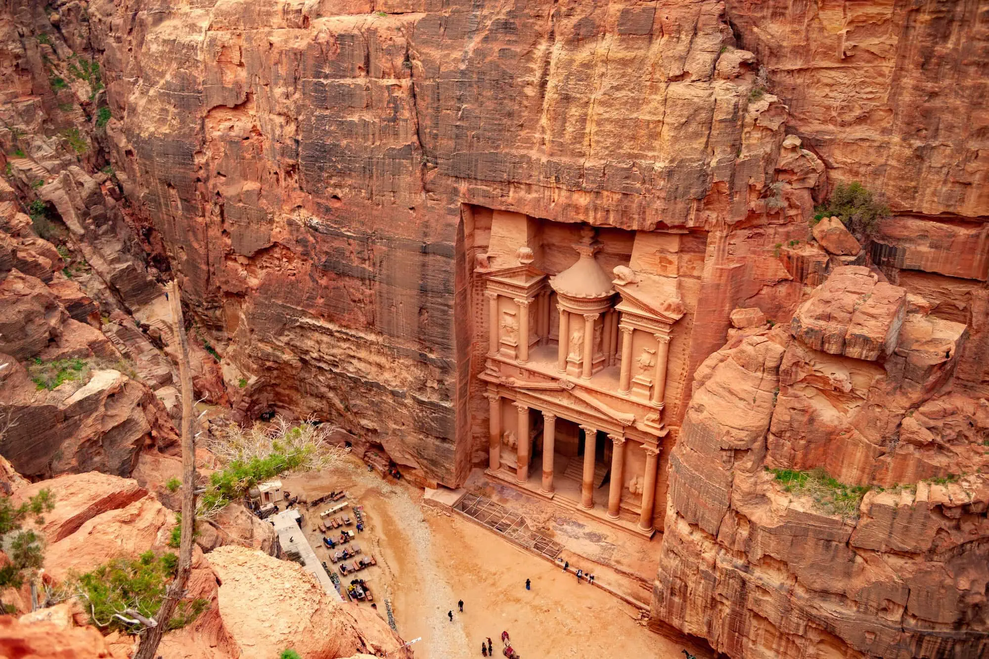 The Treasury at Petra with tourists exploring the ancient carved facade