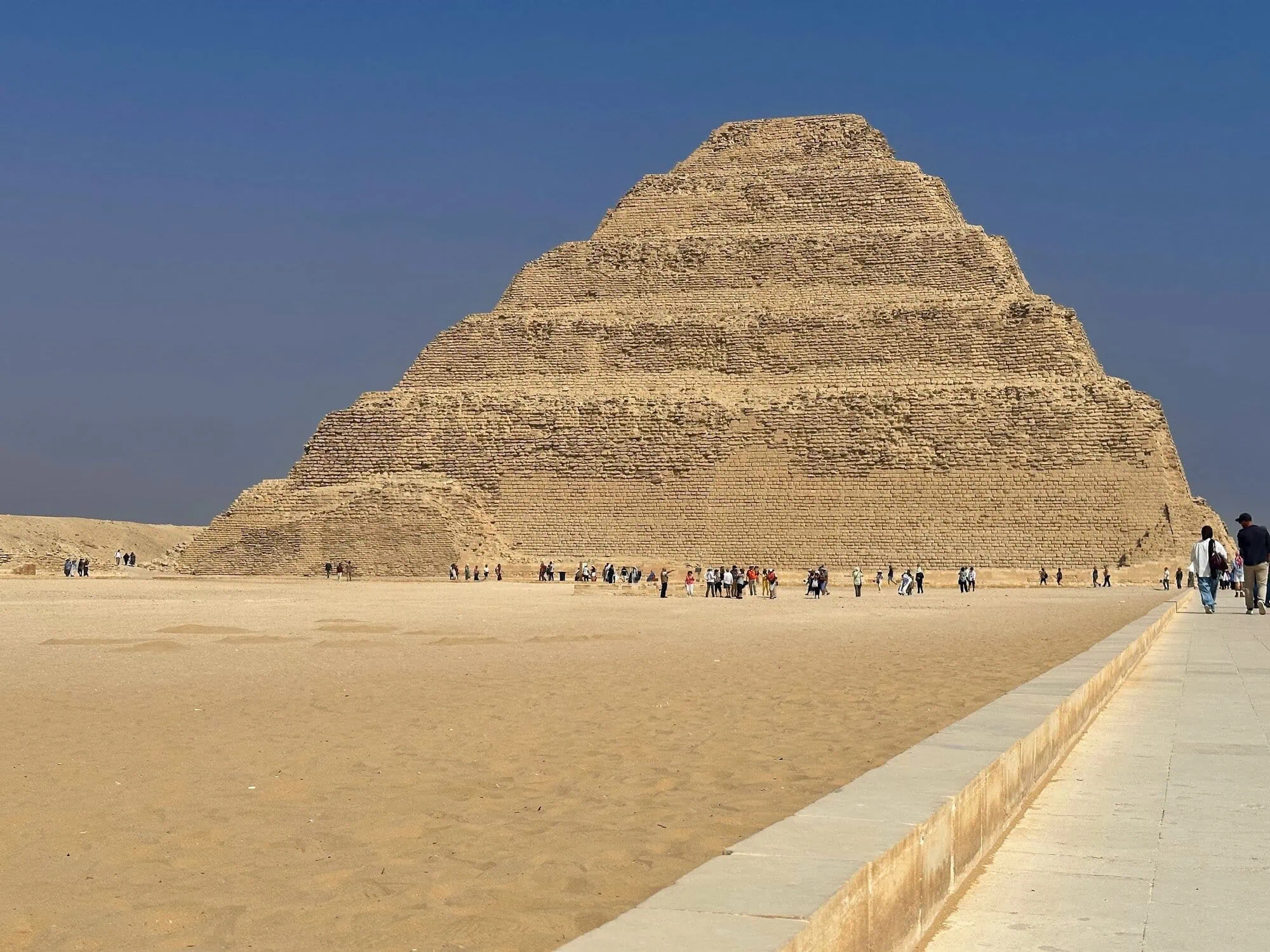 Tourists exploring the Step Pyramid of Djoser at Saqqara necropolis in Egypt