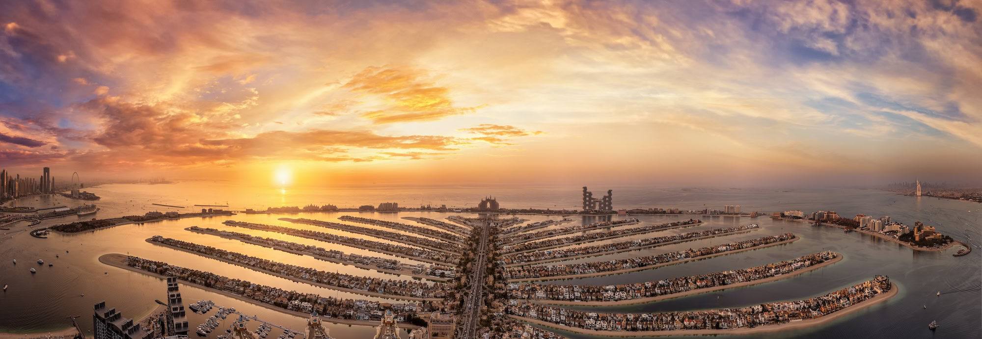 Aerial view of Dubai's Palm Jumeirah artificial island at sunset