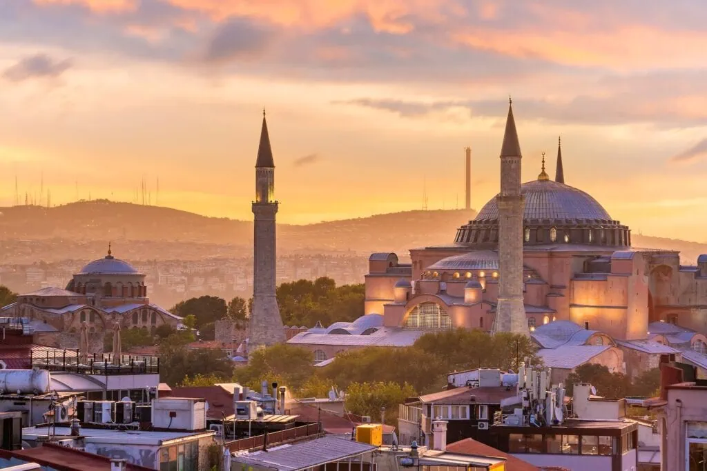 Exterior view of Hagia Sophia in Istanbul, Turkey, at sunset — the 6th-century Byzantine basilica with its central dome and four Ottoman-era minarets, originally built in 537 AD under Emperor Justinian