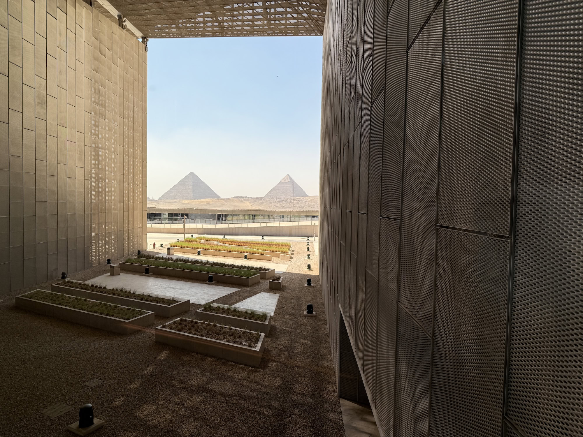 Modern luxury hotel with geometric architecture and pyramid views