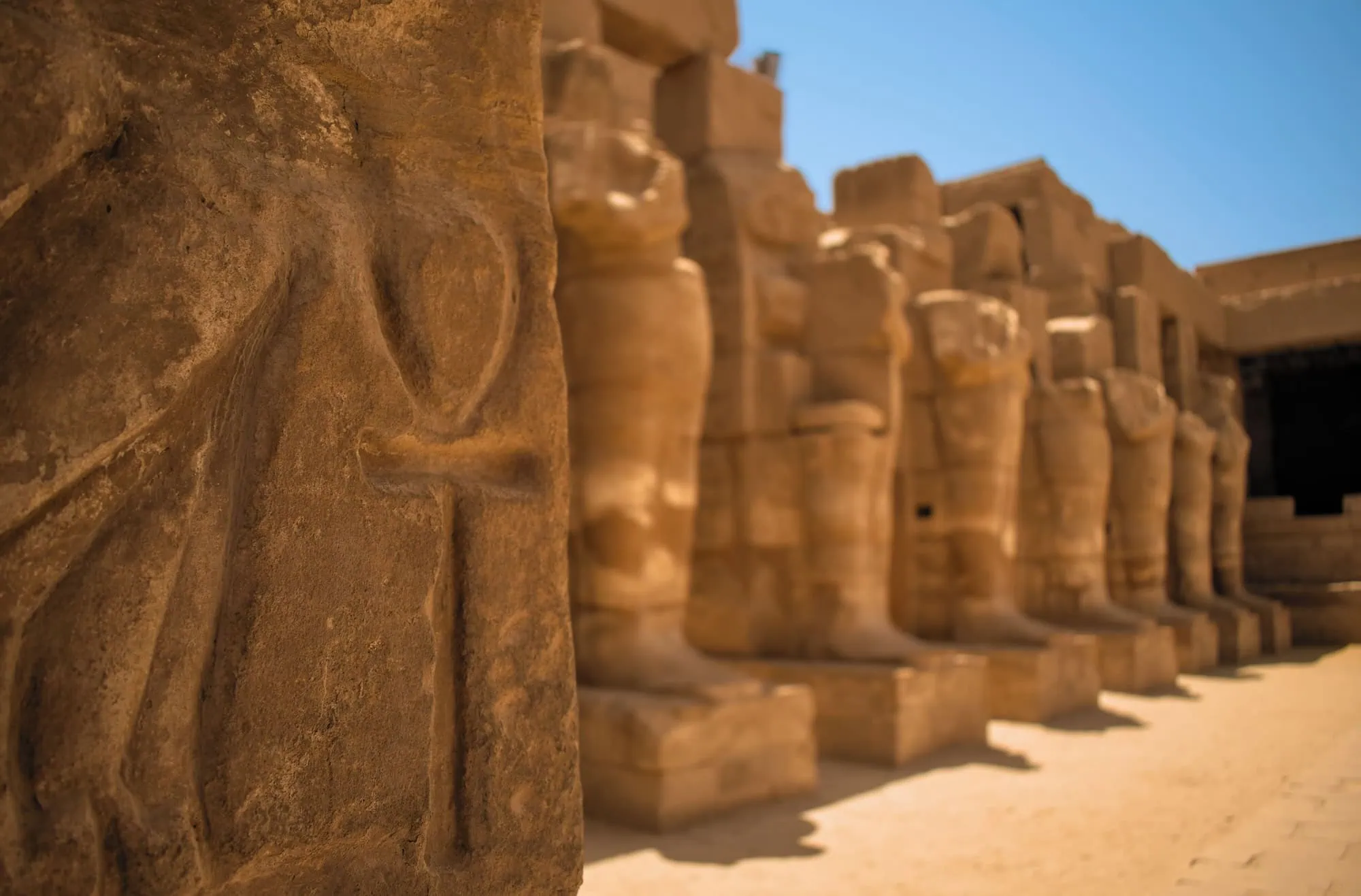 Ancient Egyptian temple columns with hieroglyphic carvings and stone pillars