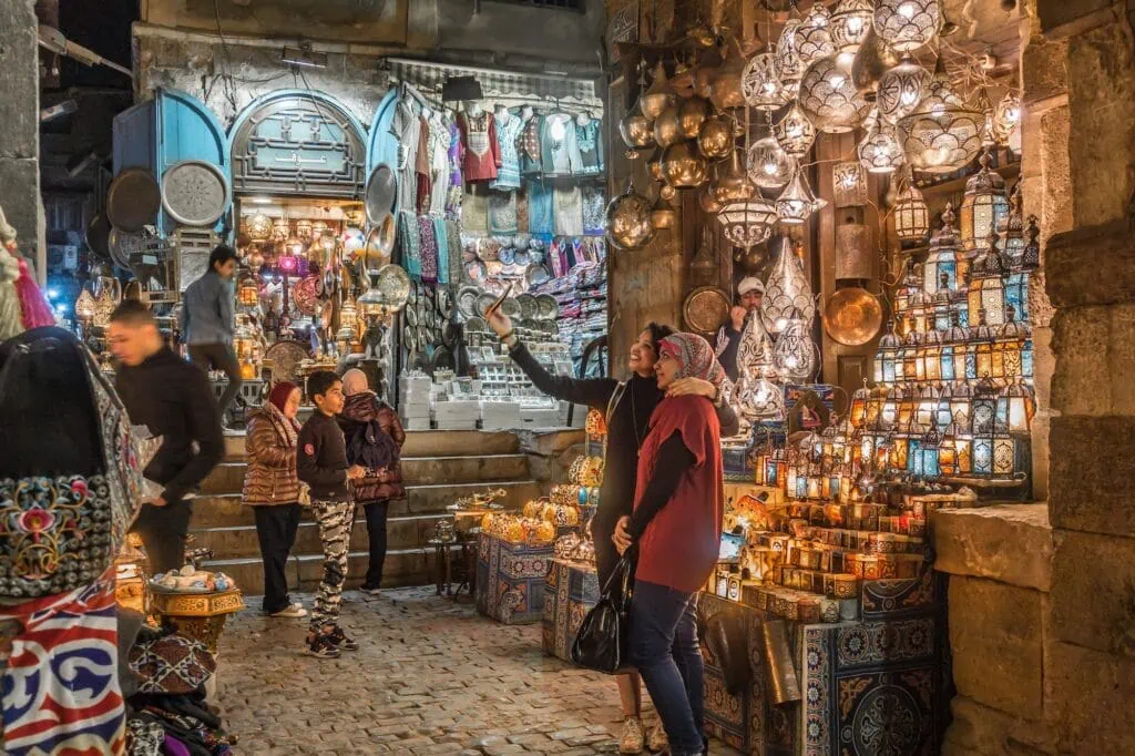 Lantern-lit alleyway in Khan el-Khalili bazaar in Old Cairo, founded in 1382 under the Mamluks and in continuous operation since, a half-day stop on the Cairo segment of an Egypt Nile cruise itinerary