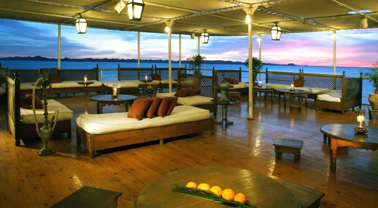 Spacious deck on Mövenpick Prince Abbas with loungers and umbrellas