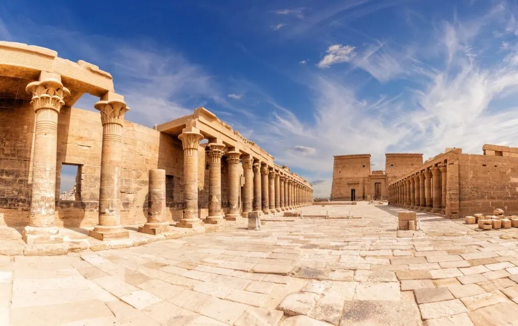 Panoramic view of Philae Temple courtyard with stone colonnades and open sky above, Aswan