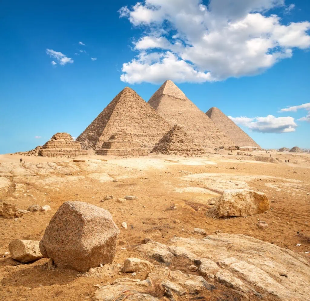 Giza in flat daylight: the three pyramids holding the horizon, seen the unhurried way, from the outside, with time to just look.