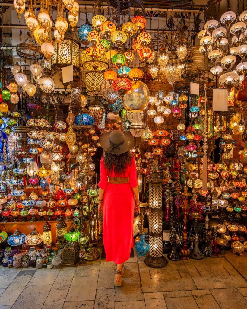 Woman standing before colorful lanterns in a Grand Bazaar shop